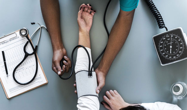 worker getting blood pressure taken