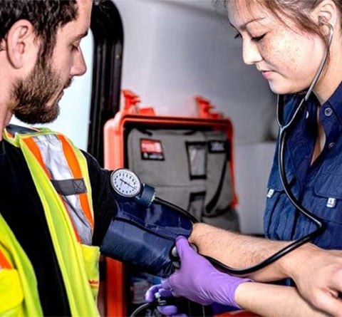 remote medical clinician taking a worker's blood pressure
