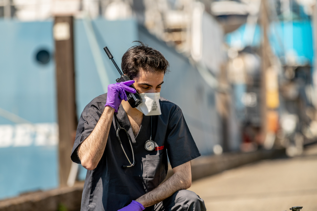 An RMI provider on a satellite phone at a maritime port.