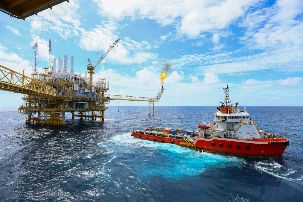 An offshore construction platform for production of oil and gas and a vessel.