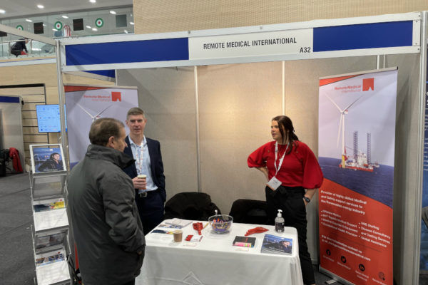 Charlene York and Dave Thompson talking with an attendee at RMI’s booth at Offshore Wind North East.